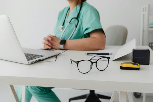 Healthcare provider at a computer, ready to consult patients who ask if they can get a medical card while on probation.